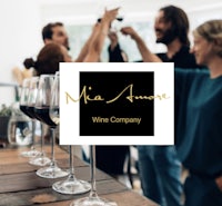 a group of people standing around a table with wine glasses